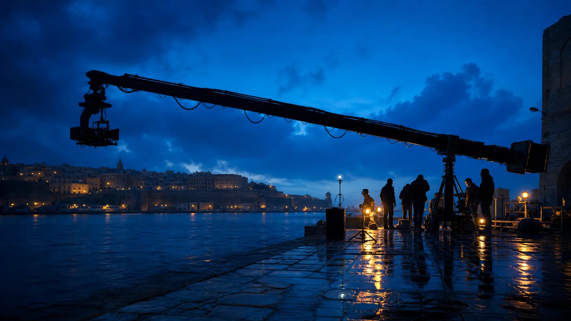 Editorial visualization of an anonymous film crew and camera crane on a Malta-inspired waterfront at blue hour